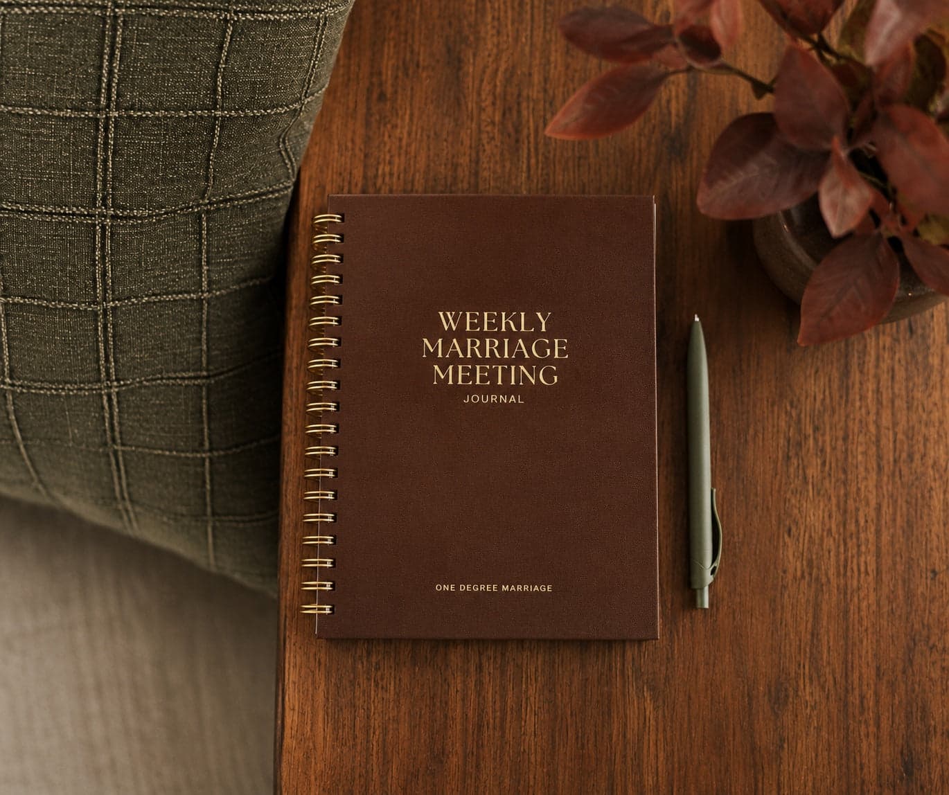 The spiral-bound Weekly Marriage Meeting Journal on a side table